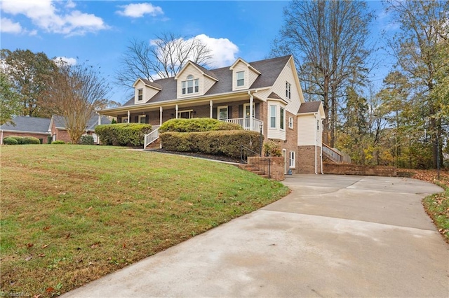 cape cod home with covered porch and a front yard