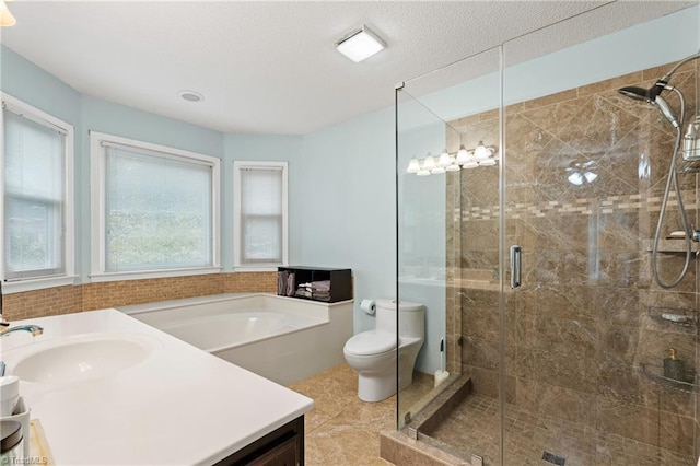 full bathroom featuring separate shower and tub, vanity, a textured ceiling, tile patterned flooring, and toilet