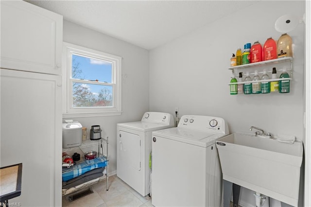 washroom featuring washing machine and clothes dryer and sink