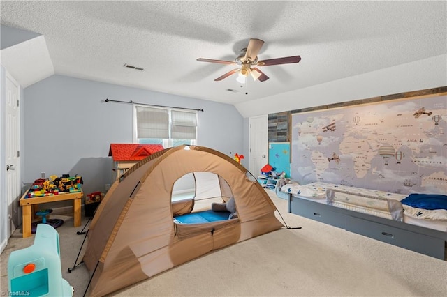 bedroom featuring ceiling fan, lofted ceiling, and carpet