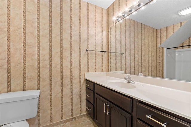 bathroom with vanity, tile patterned floors, and toilet