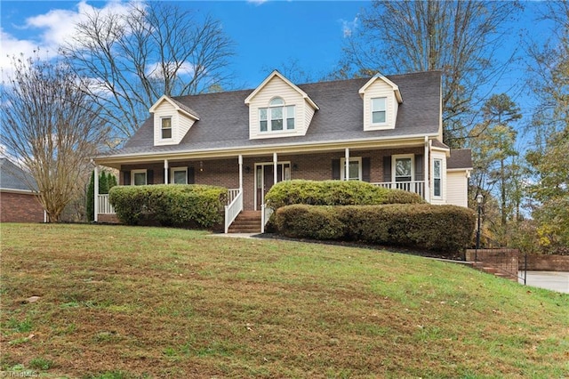 new england style home featuring a front lawn and covered porch