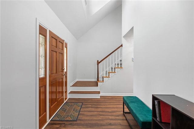 foyer entrance featuring dark hardwood / wood-style floors and high vaulted ceiling