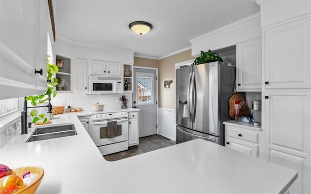 kitchen featuring ornamental molding, open shelves, a sink, white appliances, and white cabinets