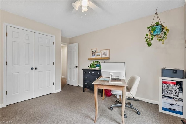 carpeted home office with baseboards