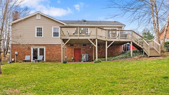 back of house featuring stairway, a lawn, and brick siding