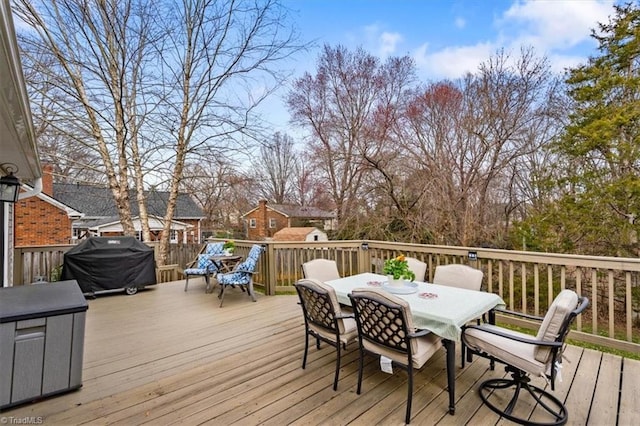 deck with outdoor dining area and area for grilling