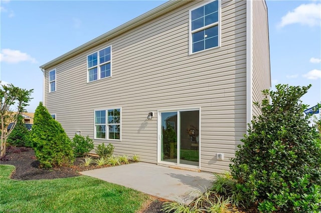 rear view of property featuring a patio area and a yard