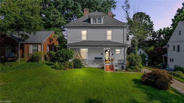 view of front of home with a yard and a porch