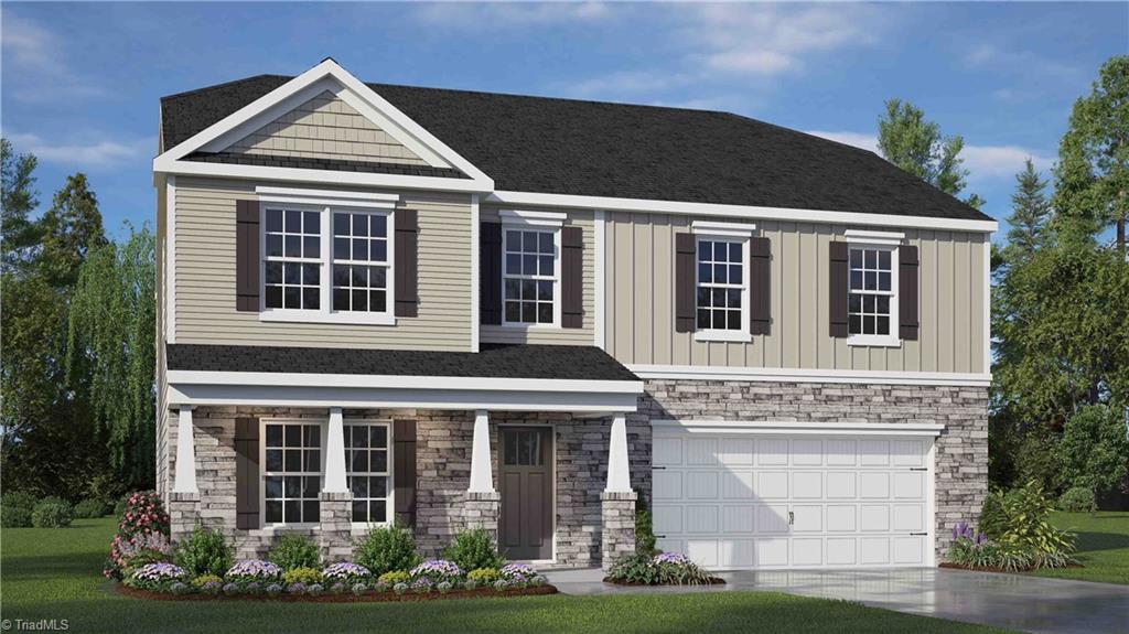 view of front of home with a garage and a front lawn