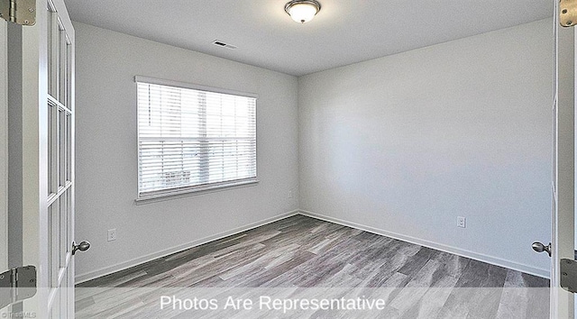 unfurnished room featuring hardwood / wood-style floors