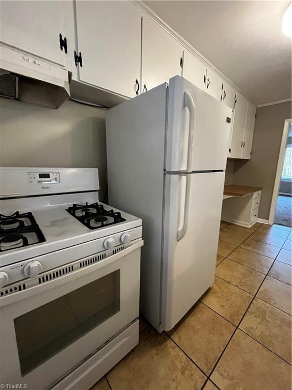 kitchen with white cabinetry, light tile patterned flooring, and white appliances