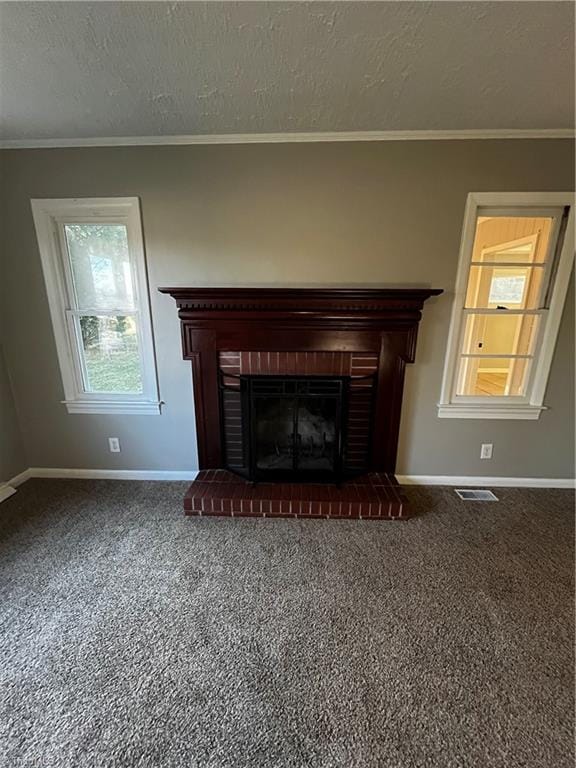 room details featuring carpet flooring, crown molding, a textured ceiling, and a brick fireplace