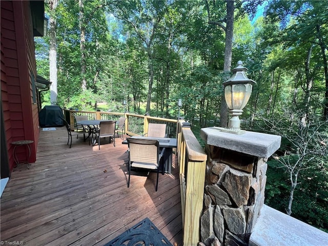 wooden terrace featuring outdoor dining area