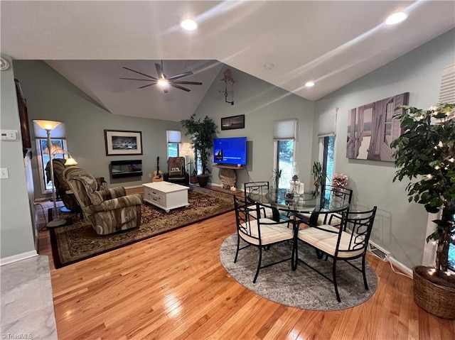 dining room featuring vaulted ceiling, a ceiling fan, wood finished floors, and recessed lighting