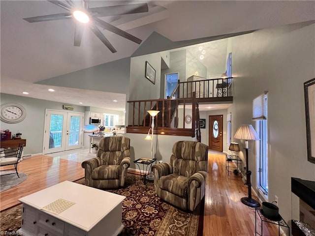 living area with high vaulted ceiling, a ceiling fan, wood finished floors, and recessed lighting