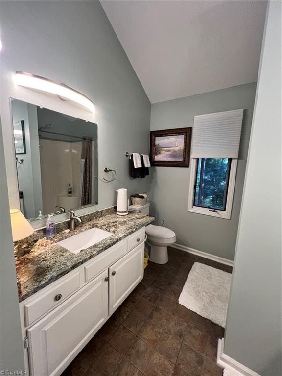 bathroom with vaulted ceiling, toilet, vanity, baseboards, and a shower with shower curtain