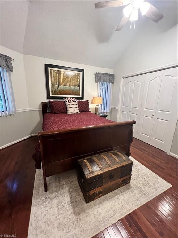 bedroom with lofted ceiling, a closet, hardwood / wood-style flooring, and ceiling fan