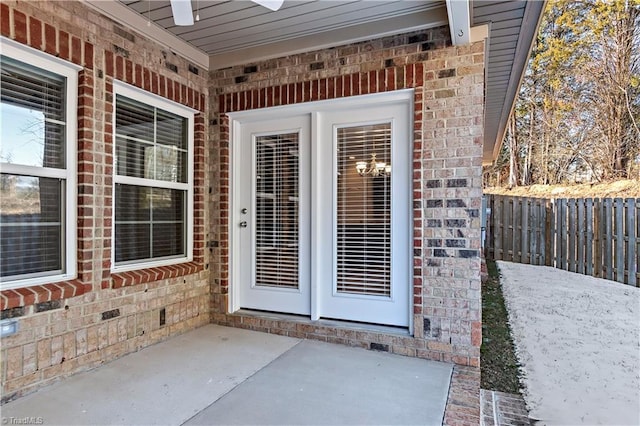 property entrance featuring ceiling fan and a patio area