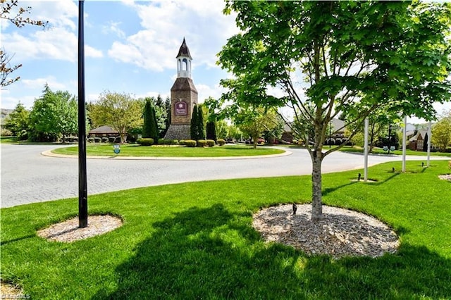 view of property's community with a lawn