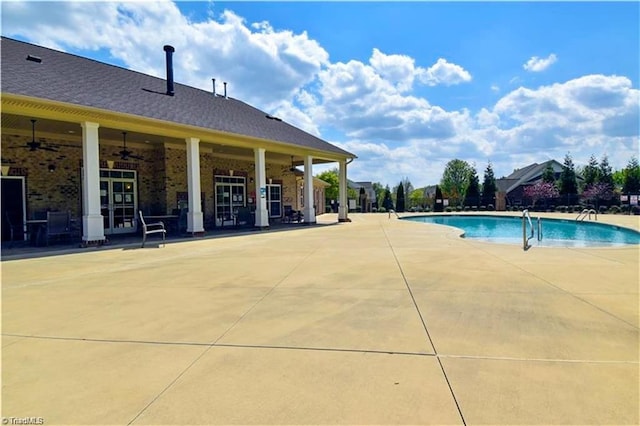 view of swimming pool featuring ceiling fan and a patio