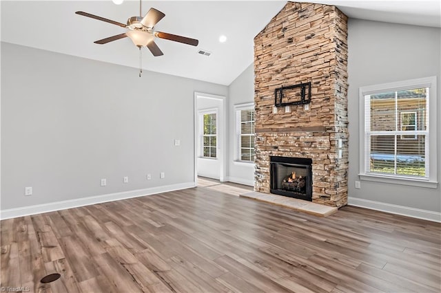 unfurnished living room featuring ceiling fan, a fireplace, high vaulted ceiling, and light hardwood / wood-style flooring