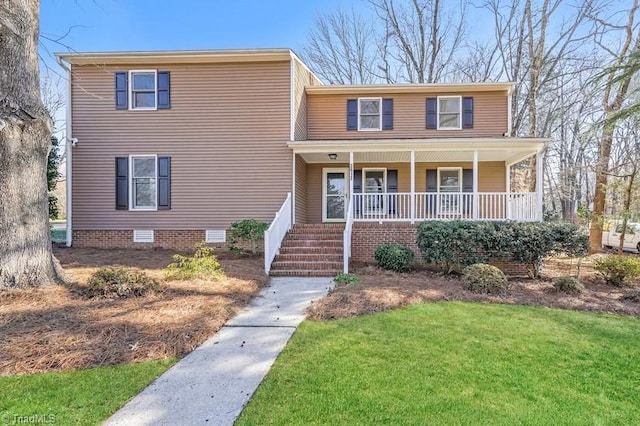 view of front of home with covered porch and a front yard