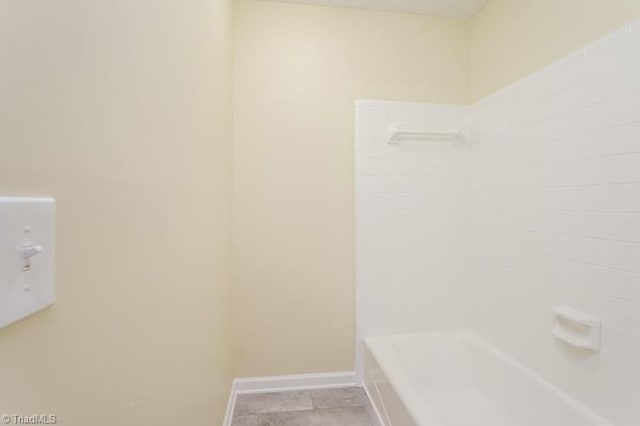 bathroom with tile patterned flooring and shower / bathtub combination