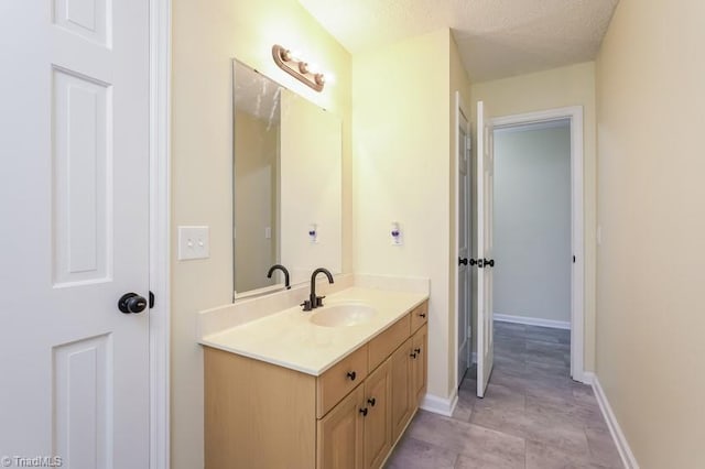 bathroom featuring vanity and a textured ceiling