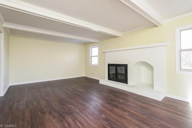 unfurnished living room featuring ornamental molding, a brick fireplace, dark wood-type flooring, and beam ceiling