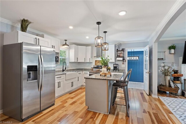 5215 Hicone Rd, Mcleansville, NC 27301 - kitchen with stainless steel appliances, a sink, white cabinets, light stone countertops, and ornamental molding