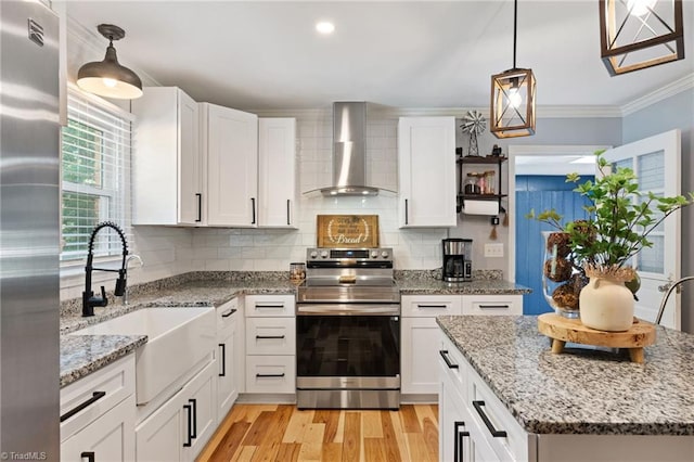 5215 Hicone Rd, Mcleansville, NC 27301 - kitchen with appliances with stainless steel finishes, wall chimney exhaust hood, a sink, light wood finished floors, and white cabinetry