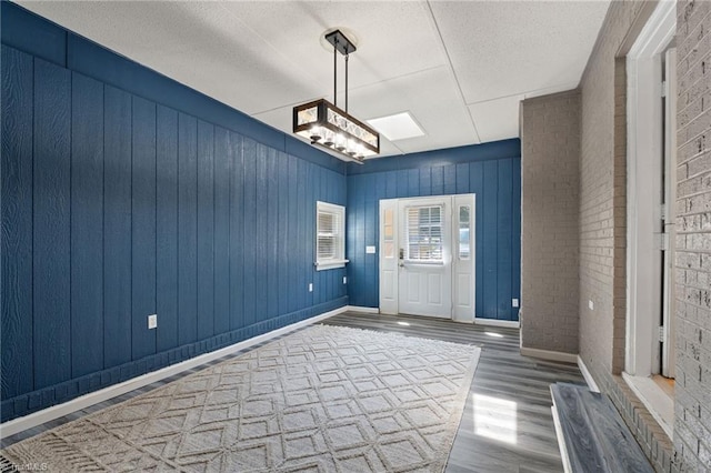 5215 Hicone Rd, Mcleansville, NC 27301 - entryway featuring wood finished floors, a textured ceiling, and baseboards