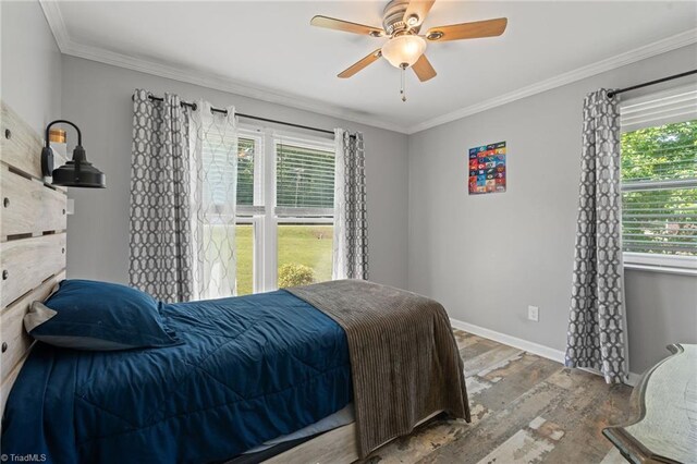 5215 Hicone Rd, Mcleansville, NC 27301 - bedroom featuring wood finished floors, multiple windows, crown molding, baseboards, and a ceiling fan