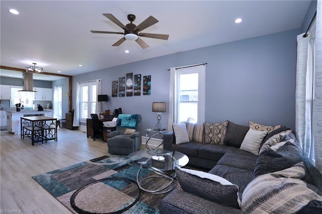 living room with recessed lighting, light wood-type flooring, and a ceiling fan