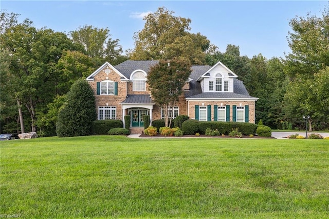8602 Yvonne Ct, Oak Ridge, NC 27310 - view of front facade with a front yard and brick siding