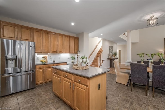 8602 Yvonne Ct, Oak Ridge, NC 27310 - kitchen with recessed lighting, a center island, stainless steel refrigerator with ice dispenser, dark countertops, and ornate columns