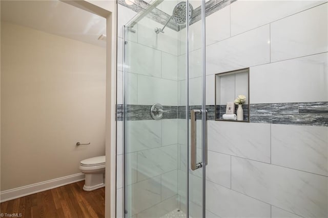 8602 Yvonne Ct, Oak Ridge, NC 27310 - bathroom featuring toilet, baseboards, a shower stall, and wood finished floors