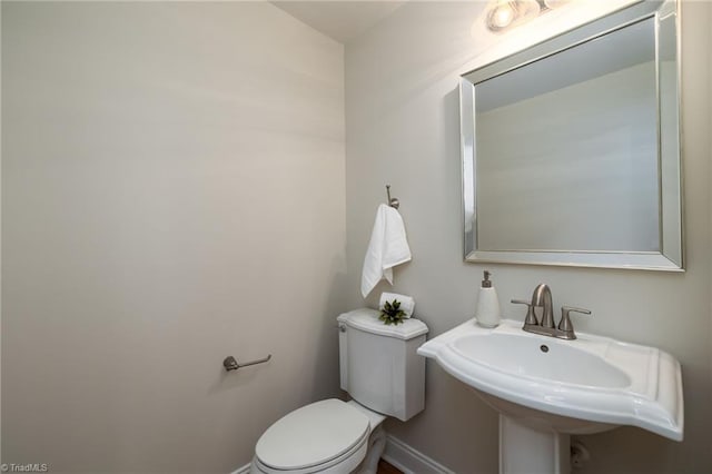 8602 Yvonne Ct, Oak Ridge, NC 27310 - bathroom featuring toilet, baseboards, and a sink