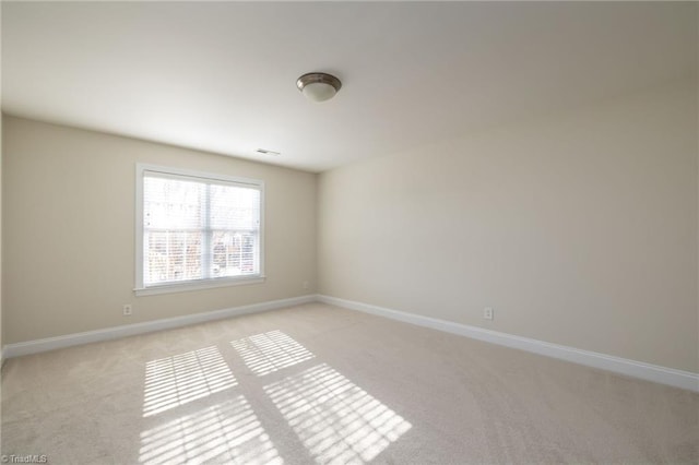 8602 Yvonne Ct, Oak Ridge, NC 27310 - unfurnished room featuring baseboards, light carpet, and visible vents