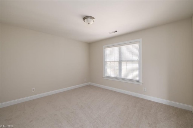 8602 Yvonne Ct, Oak Ridge, NC 27310 - spare room with light colored carpet, visible vents, and baseboards