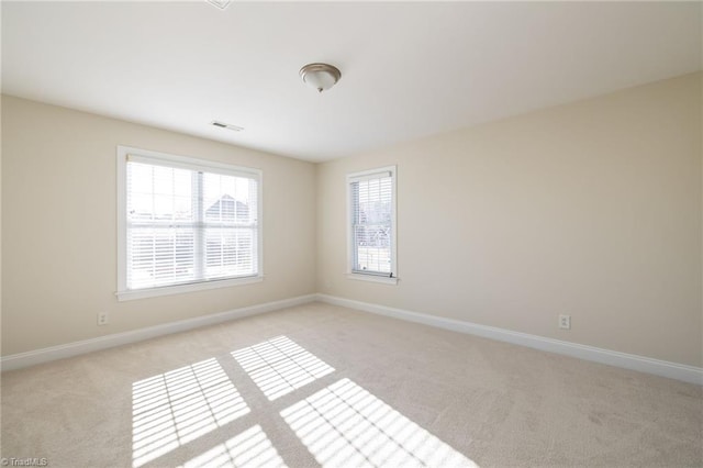 8602 Yvonne Ct, Oak Ridge, NC 27310 - unfurnished room with light colored carpet, baseboards, and visible vents