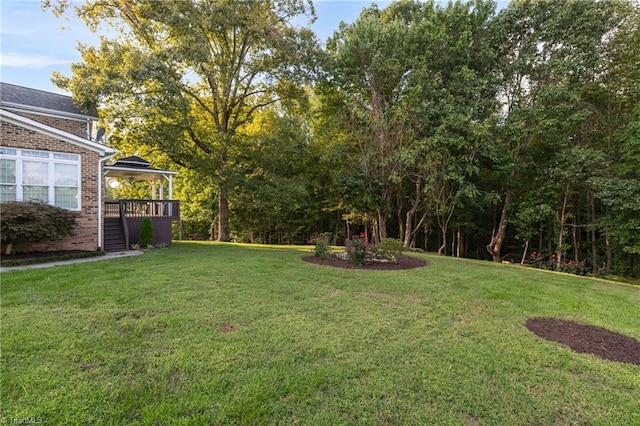 view of yard featuring a wooden deck