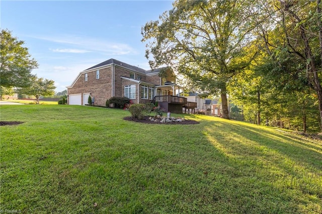 view of yard with a garage and a deck