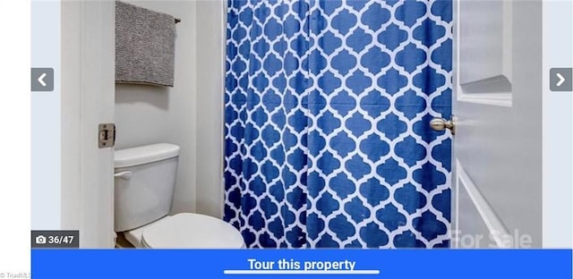 7464 Albemarle Ct, Denver, NC 28037 - bathroom with toilet and a shower with shower curtain