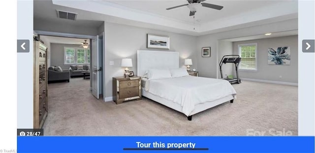 7464 Albemarle Ct, Denver, NC 28037 - carpeted bedroom featuring multiple windows, a tray ceiling, and a ceiling fan