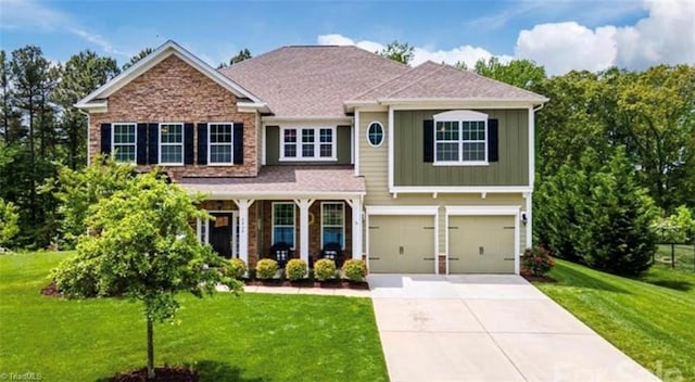 7464 Albemarle Ct, Denver, NC 28037 - view of front of home with concrete driveway, board and batten siding, a front yard, and a garage