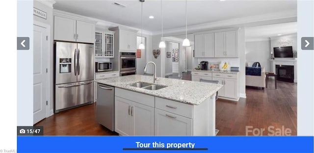 7464 Albemarle Ct, Denver, NC 28037 - kitchen with stainless steel appliances, glass insert cabinets, decorative light fixtures, dark wood-style flooring, and light stone countertops