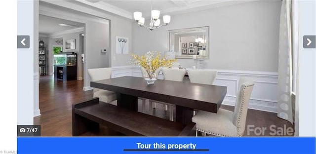 7464 Albemarle Ct, Denver, NC 28037 - dining area featuring a chandelier, wood finished floors, a wainscoted wall, crown molding, and a decorative wall