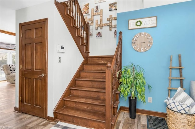 1705 Braemore Ct, Kernersville, NC 27284 - stairs with baseboards, wood finished floors, and visible vents